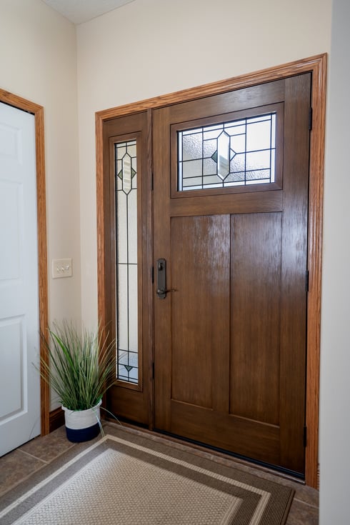 ProVia Signet Fir fiberglass entry door with a sidelight in English Chestnut stain with Brookhaven decorative glass