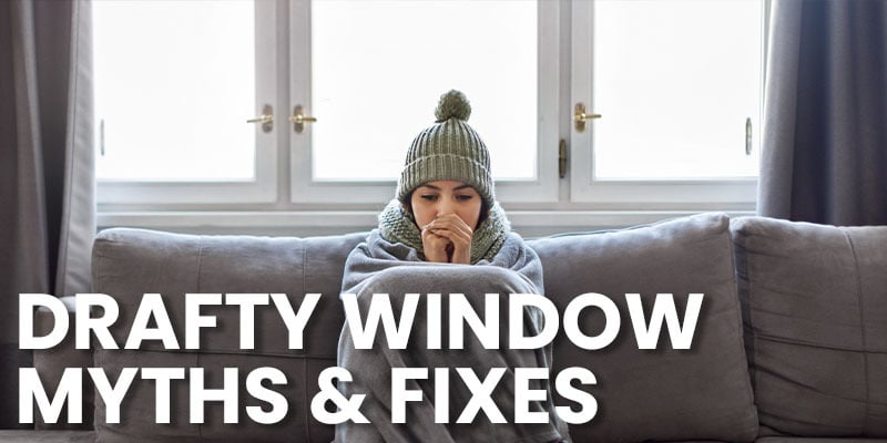 woman sitting on couch is a cold living rom with a hat on