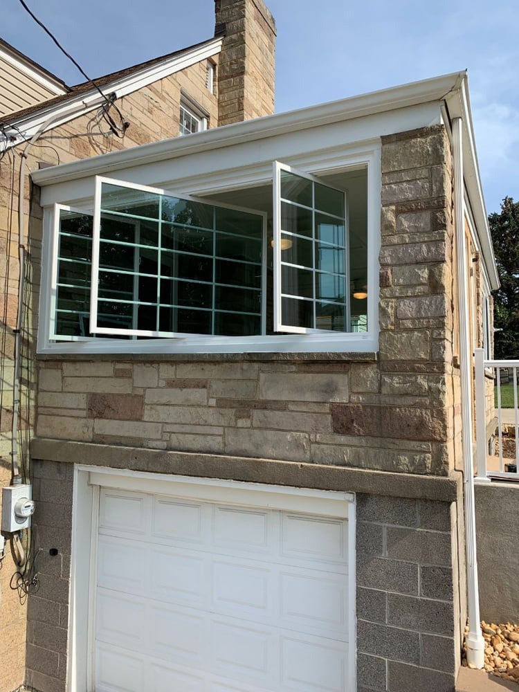 Energy Swing 3-lite slider with both side sashes pivoted open for cleaning on a stone home