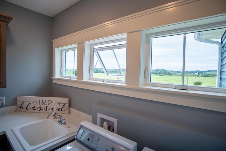 ProVia Endure awning windows in a laundry room with the center sash open outward
