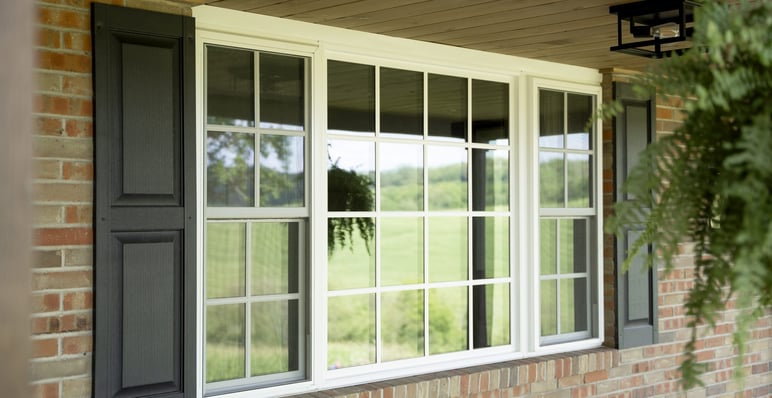 three lite vinyl window on brick home