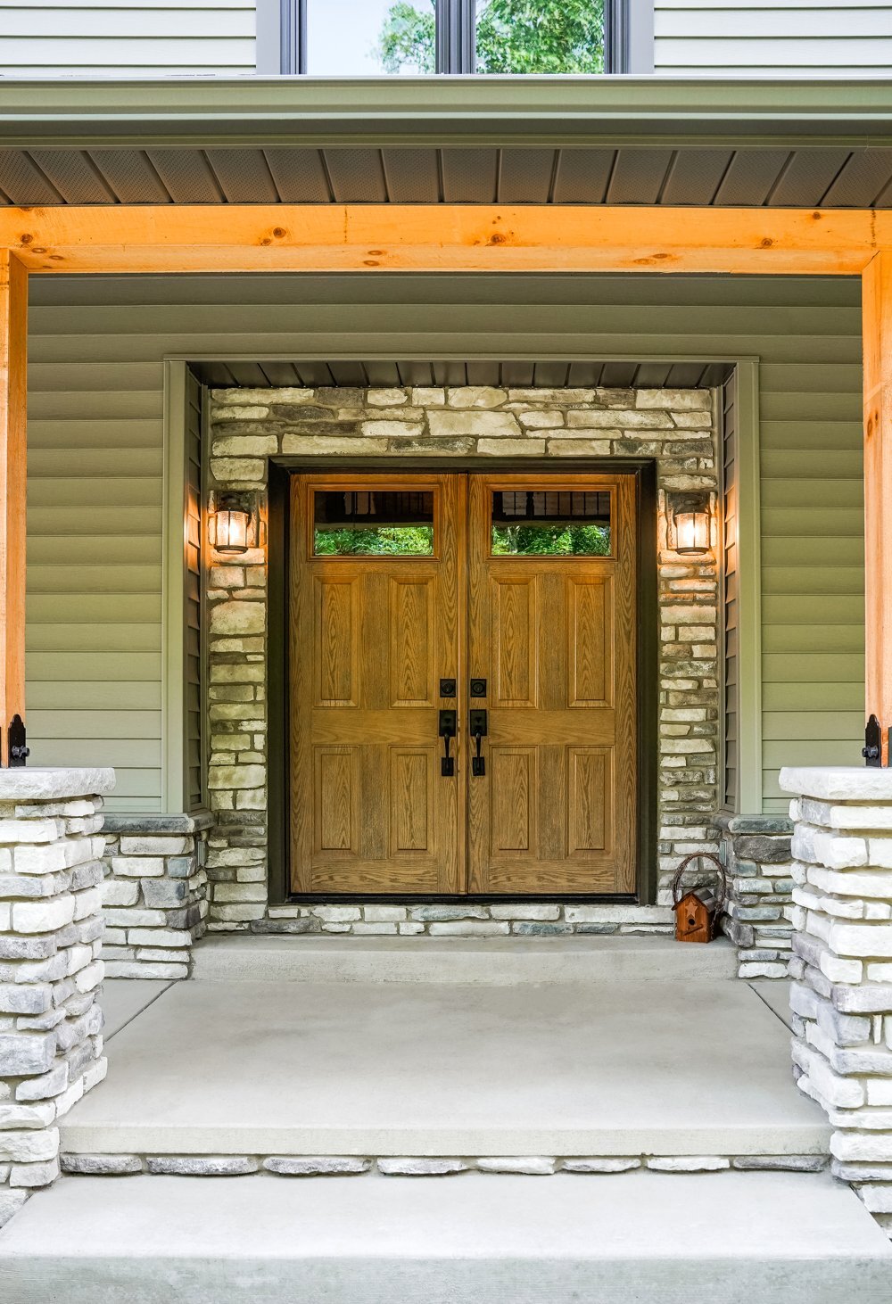 Woodgrain ProVia steel double entry doors with top glass lites
