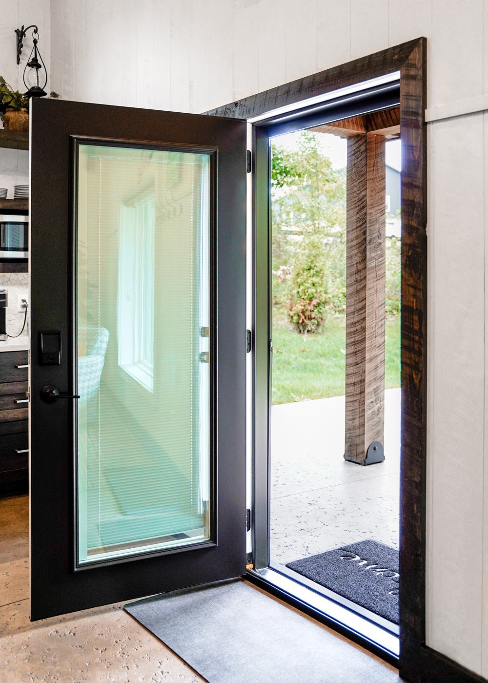 Black full-glass ProVia steel door swung open