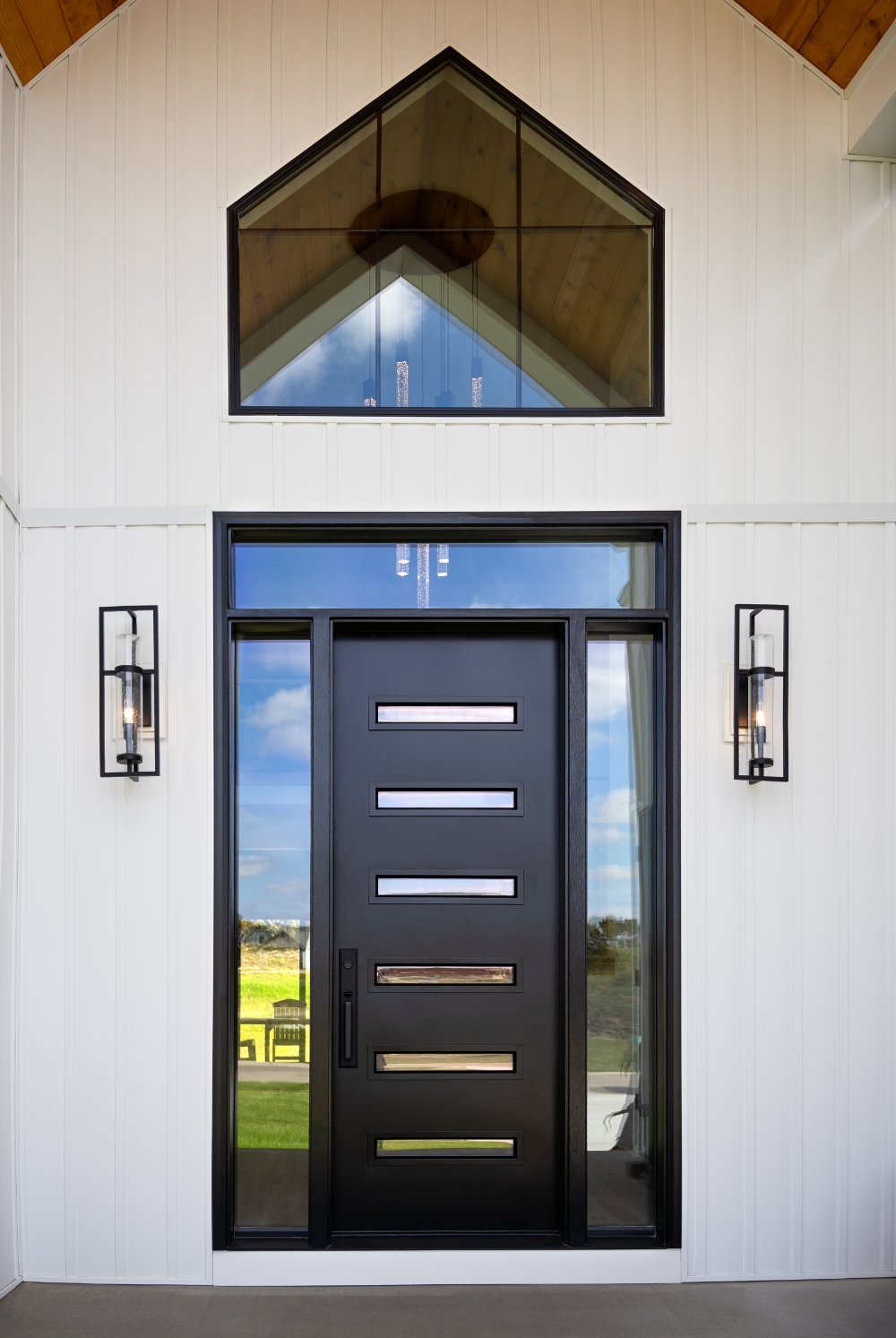 Black ProVia steel entry door with modern glass lites, sidelites, and a transom