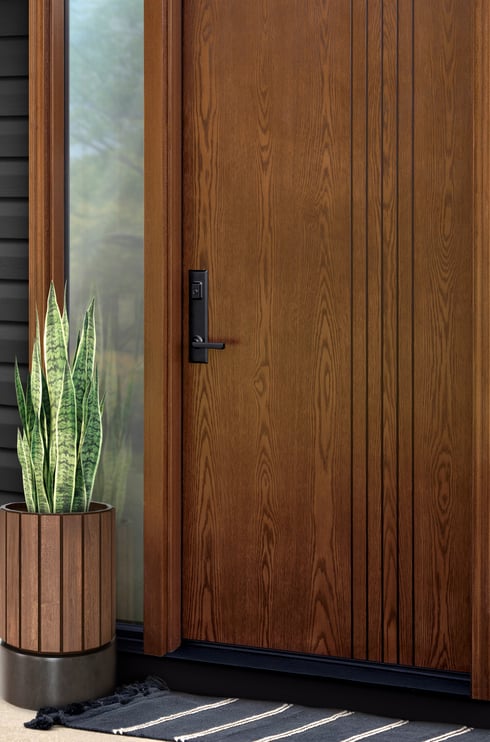 ProVia Ascent fiberglass entry door with a sidelight in Aged Barrel stain with a black Westcott handle
