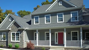 Gray two-story home with a red front door and a covered porch