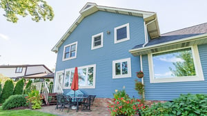 Blue-sided home with a backyard patio