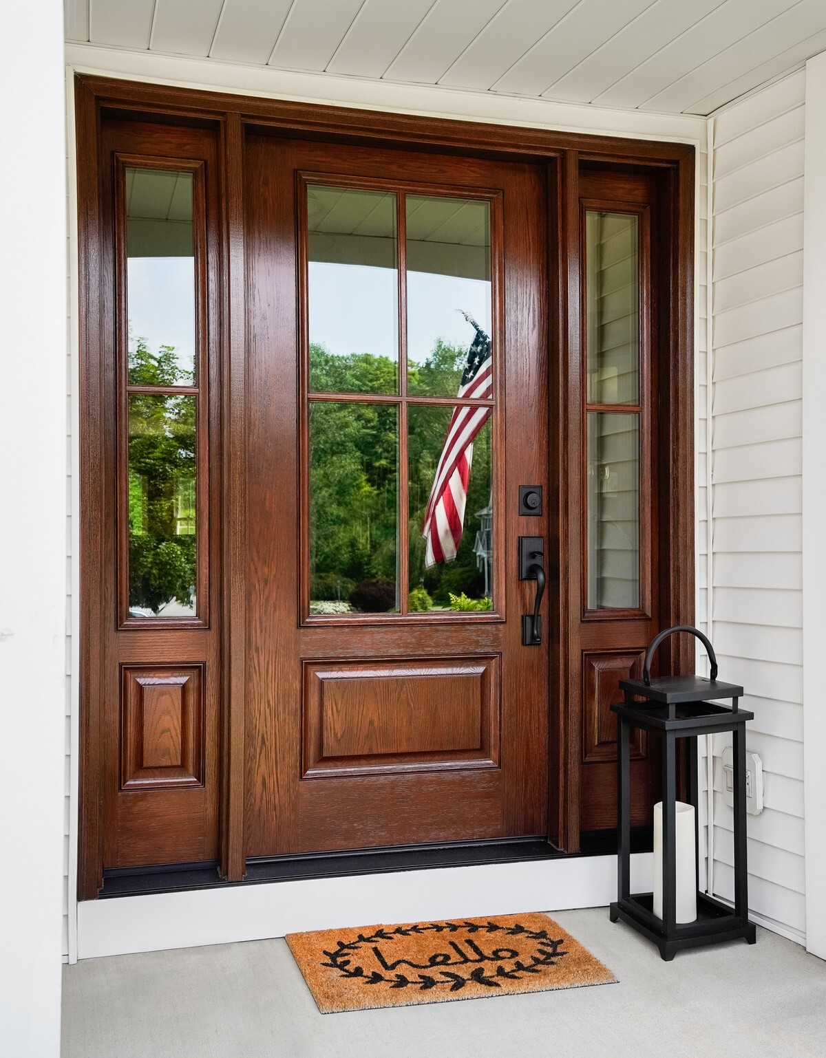 ProVia Signet Oak fiberglass entry door in Truffle stain with sidelites on a front porch
