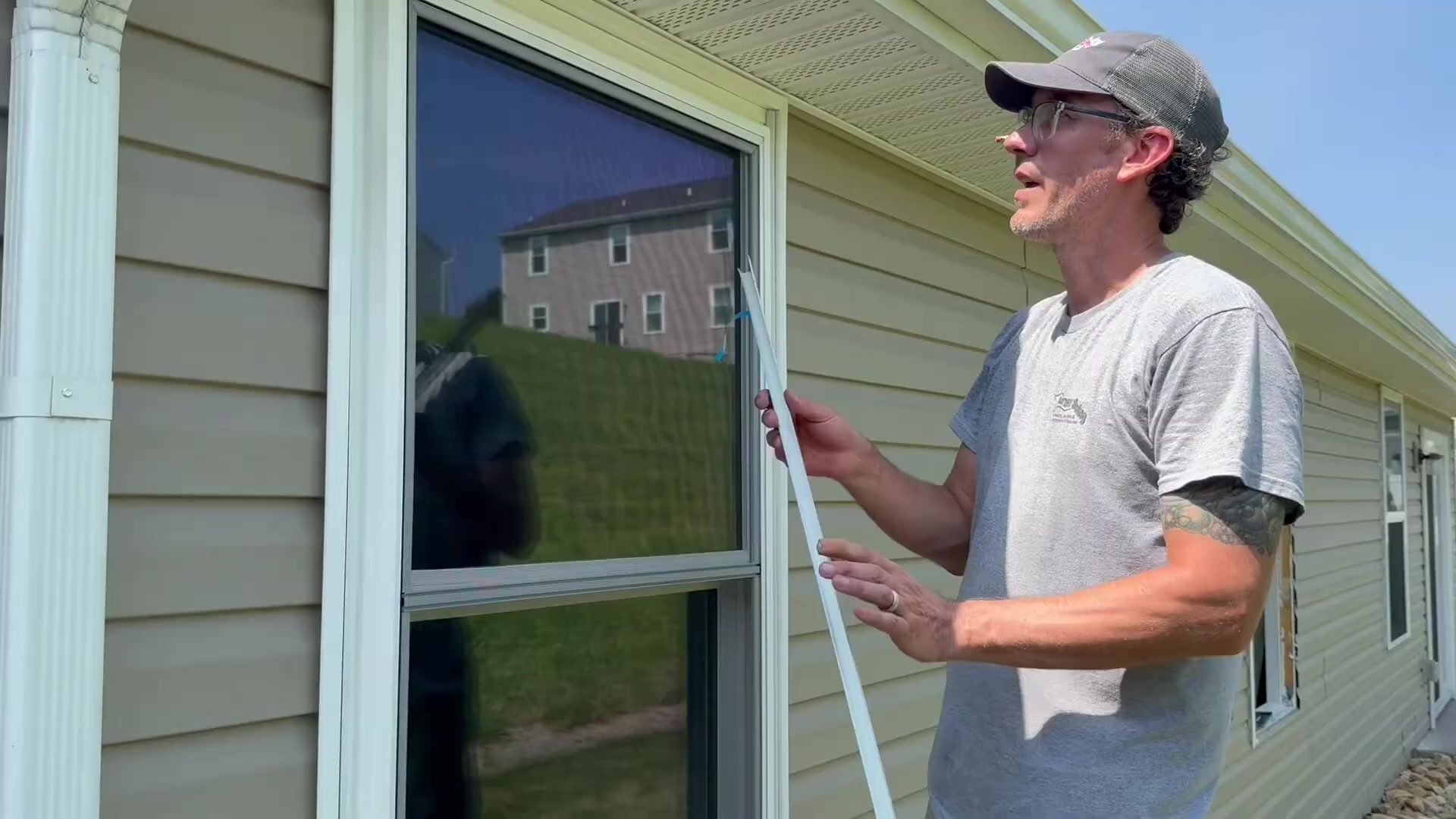 Energy Swing installer holding a length of J-channel trim