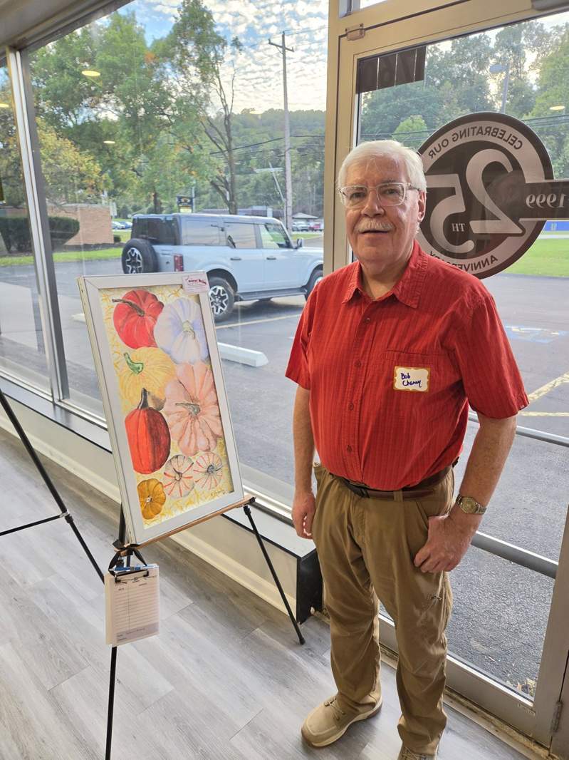 Community member with autumn pumpkins on a reclaimed window at the October 1, 2026 Design Center event