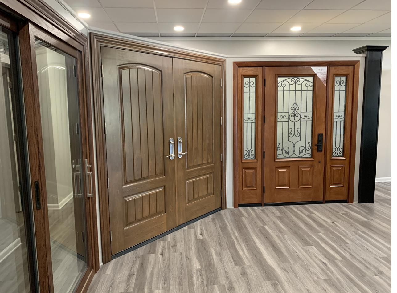 Showroom display of ProVia entry doors in warm wood finishes
