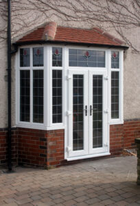 French doors on a home with red roofing